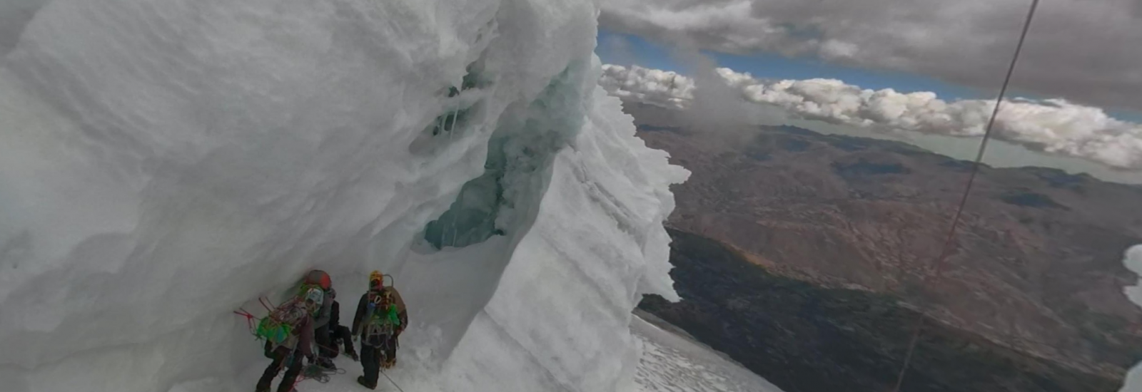 researchers climbing a glacier in the mountains