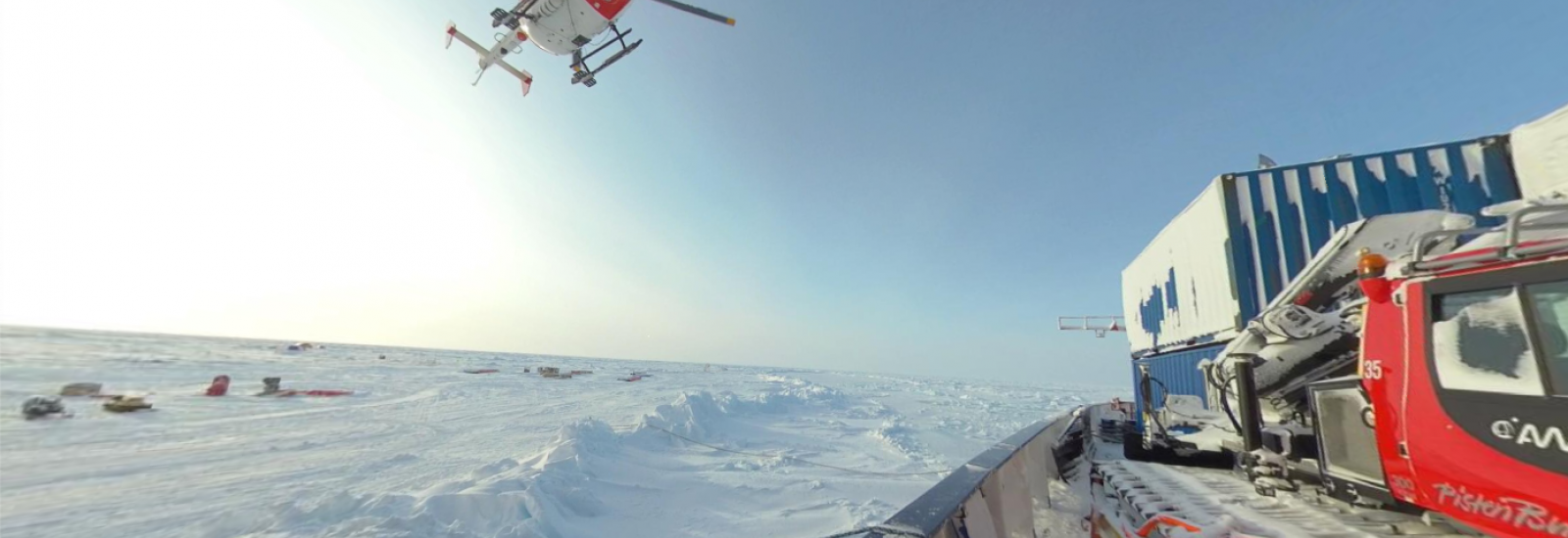 helicopter arriving on a ship frozen in sea ice
