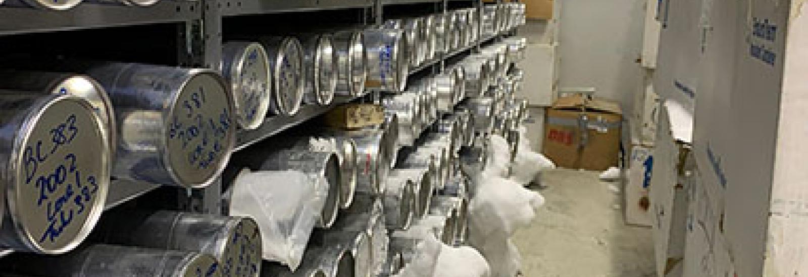 Ice core tubes on shelving with frost build up and ice overflowing onto ground