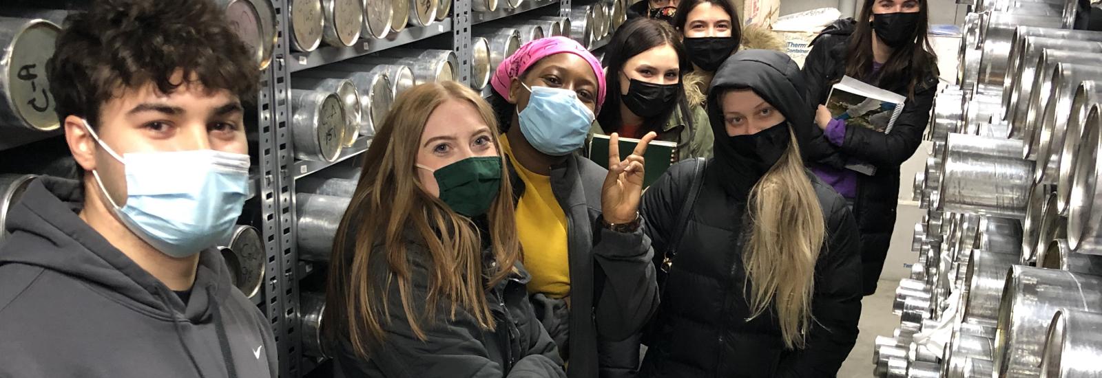 students inside the ice core freezer with silver core tubes