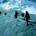Researchers trek across Himalayan ridge-line.