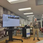 Bryan Mark presenting at the monitor.