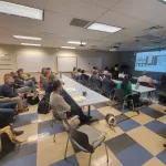 Geddy Davis presenting to an audience.