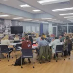 A group seated waiting for a presentation.