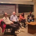Panel of four people sitting around for a discussion.
