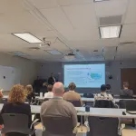 Two people speaking to an audience.