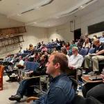 A crowd sitting in an auditorium.