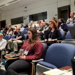 A crowd sitting in an auditorium.