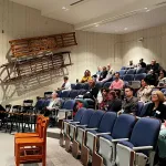 A crowd sitting in an auditorium.
