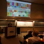 Heidi Roop speaking to an audience in the auditorium.