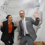 Heidi Roop and Jason Cervenec smiling and waving at the camera.