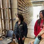 Three people standing in the Polar Rock Repository on person approaching in a distance.