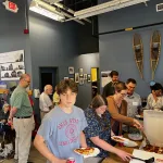 A group standing and getting food.