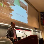 Jason Cervenec presenting at the podium.
