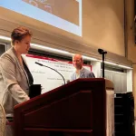 Karina Peggau at the podium and Jamey walking over.