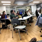 An audience seated in a room. 