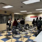 People standing around and talking during the poster session.