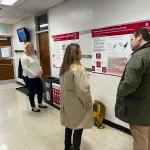 People standing around and talking during the poster session.