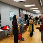 People standing around and talking during the poster session.