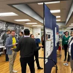 People standing around and talking during the poster session.