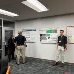 People standing around and talking during the poster session.
