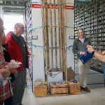 A person is presenting to an audience in a repository facility.
