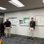 People standing around and talking during the poster session.