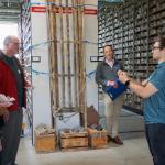 A person is presenting to an audience in a repository facility.