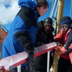 Dr. Lonnie Thompson and two other scientists hold an ice core at the summit of Quelccaya in 2003.